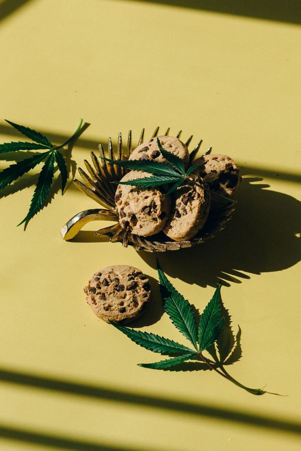 Cookies on a gold tray with cannabis leaves