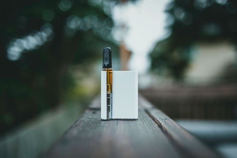 Vape device resting on a wooden ledge
