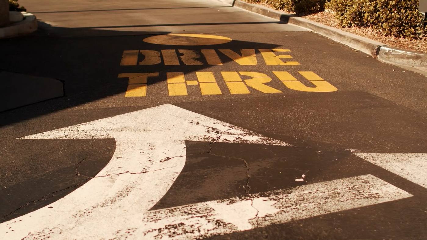Drive-thru lane marking painted on asphalt