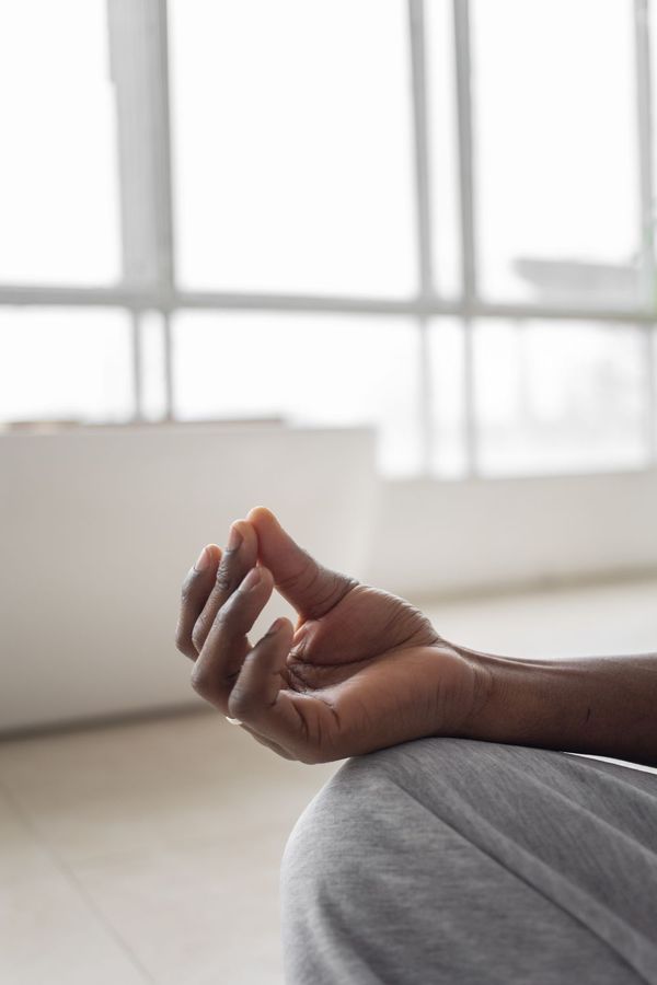 Hand resting in a meditation pose