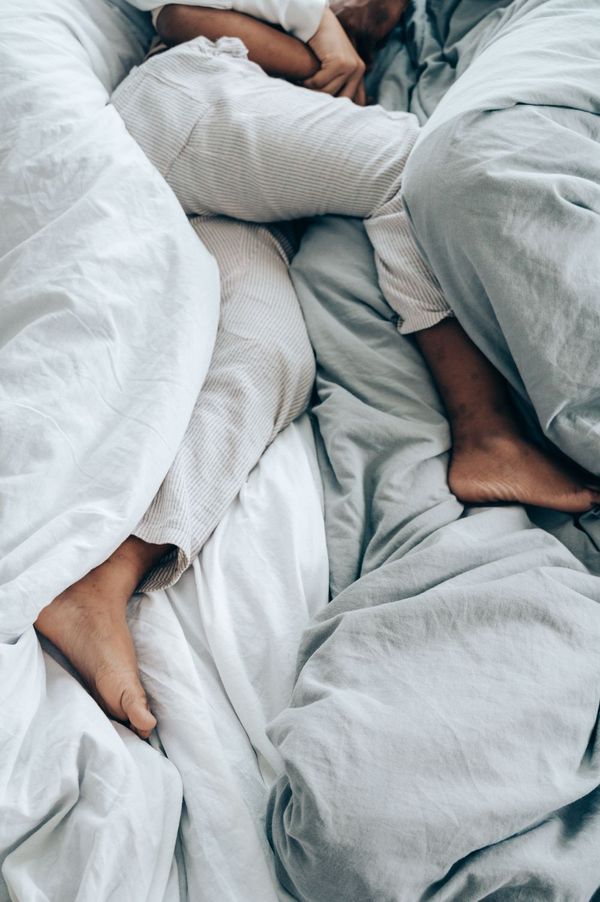 Person asleep in white bedding