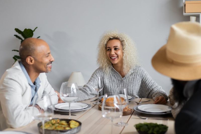 Adults talking over dinner at a table